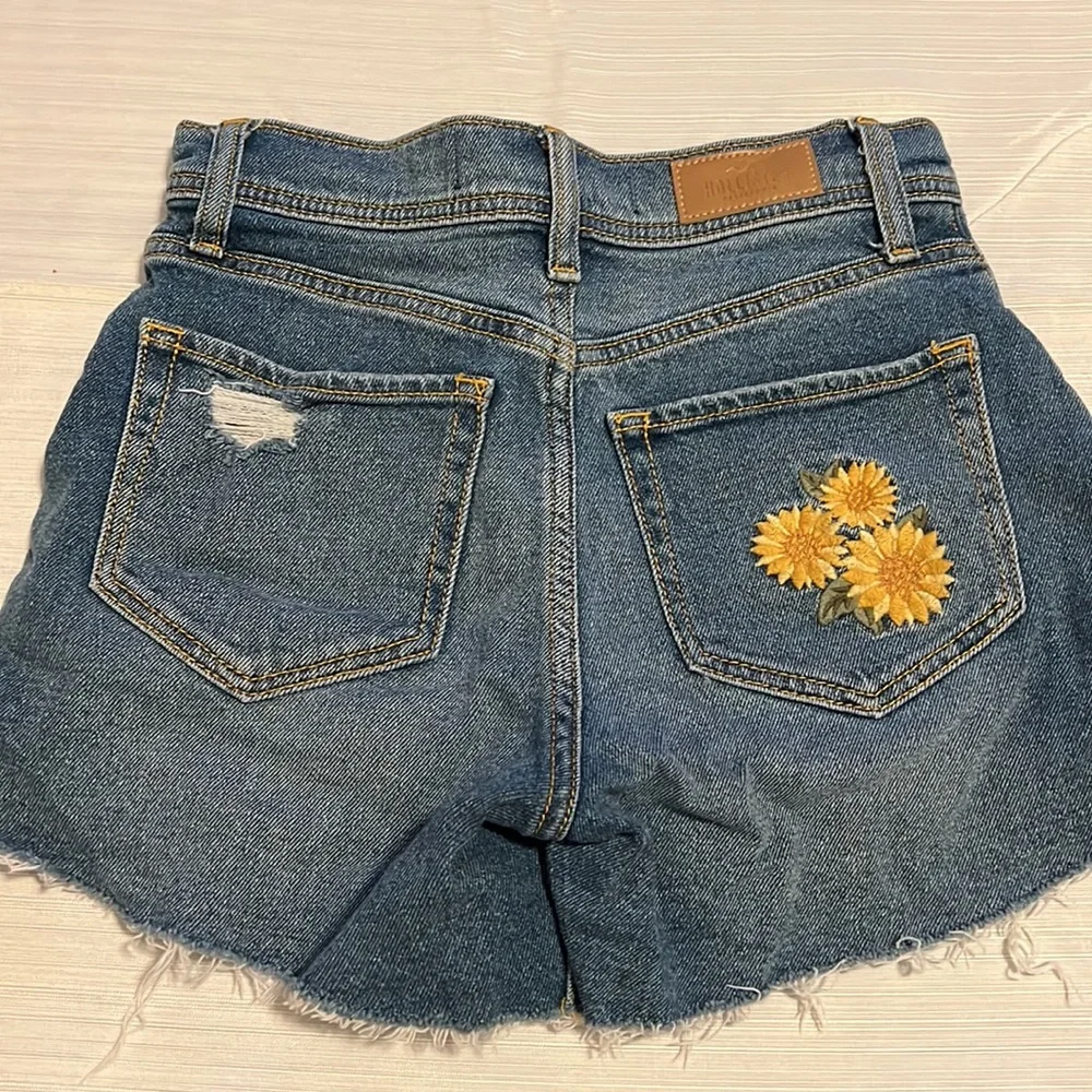 Hollister high rise vintage distressed jean shorts with sunflowers. - Picture 2 of 3